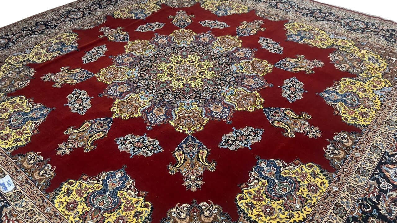 "Exquisite Isfahan rug featuring a bold crimson field, detailed yellow medallion, and intricate floral patterns."